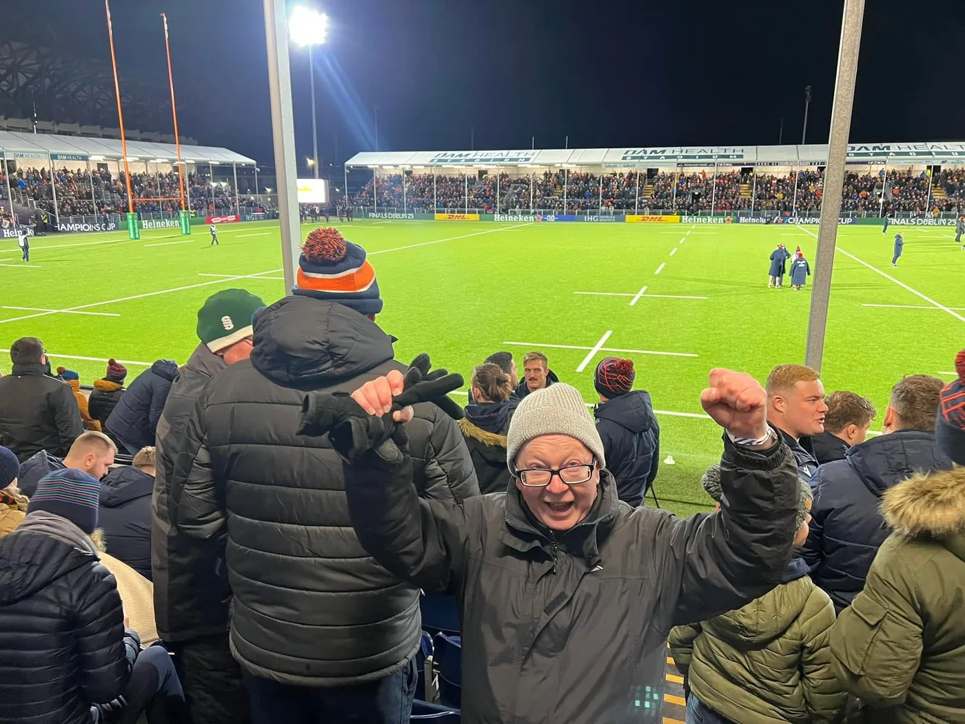 Team members together in the stands at a football match